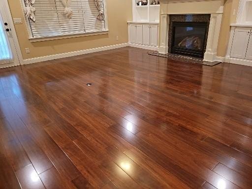 Laminate wood-look flooring installed in a Cullman AL living room by Hunter’s Ridge Construction