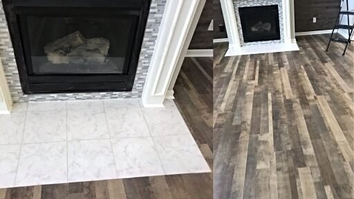 Vinyl plank flooring installed around a tiled fireplace in a Cullman, Alabama living room by Hunter's Ridge Construction.