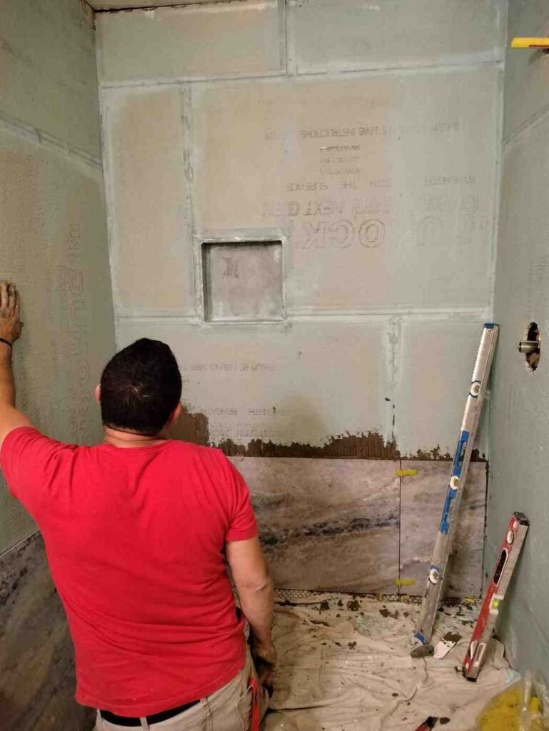 Before: shower remodel prep with cement board and niche opening before tile installation